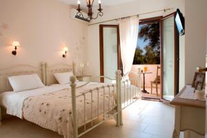 a bedroom with a bed and a balcony at Kores Villas in Nydri