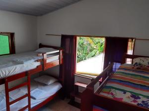 a bedroom with two bunk beds and a window at Cabañas Maikü Selva in Puerto Nariño
