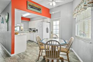 a kitchen and dining room with a table and chairs at Ocean Front Top Floor corner Penthouse condo in Surf Club will sleep up to 6 in Palm Coast