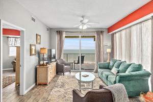 a living room with a couch and a table at Ocean Front Top Floor corner Penthouse condo in Surf Club will sleep up to 6 in Palm Coast