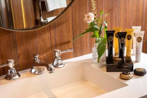 a bathroom sink with a coffee maker on it at Hotel Maison FL in Paris