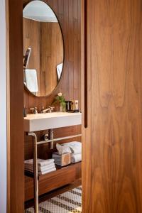a bathroom with a sink and a mirror at Hotel Maison FL in Paris