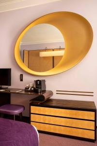 a mirror on the wall of a hotel room at Hotel Maison FL in Paris
