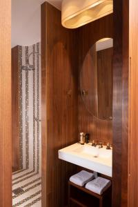 a bathroom with a sink and a shower at Hotel Maison FL in Paris