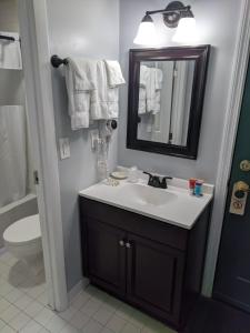 a bathroom with a sink and a mirror at Eastern Inn & Suites (formerly Eastern Inns) in North Conway
