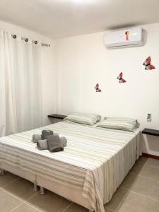 a bedroom with a large bed with towels on it at Dream Village Cumbuco Beach in Cumbuco