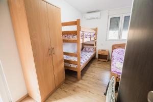 a room with two bunk beds and a closet at Rooms Vila Medena in Brežice