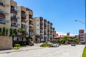 a parking lot in front of a large building at Apartamento Ingleses Norte in Florianópolis