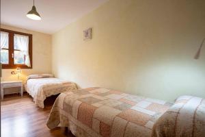 Łóżko lub łóżka w pokoju w obiekcie Apartamentos Onki Xin