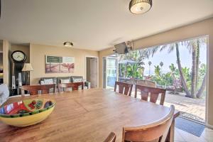 a dining room and living room with a table and chairs at Tropical Home - 200-Yard Walk to Beach Entrance! in Oceanside