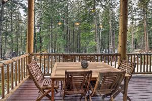 a wooden table and chairs on a wooden deck at Beautiful Leavenworth Cabin Getaway with Hot Tub! in Leavenworth