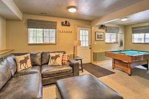 a living room with a couch and a pool table at Beautiful Leavenworth Cabin Getaway with Hot Tub! in Leavenworth