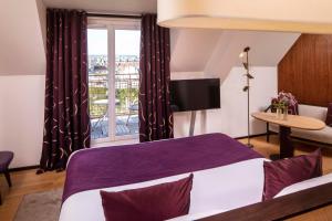 a bedroom with a purple bed and a window at Hotel Maison FL in Paris