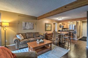 a living room with a couch and a table at Cozy Bellaire Condo with Balcony - 3 Mi to Skiing! in Bellaire