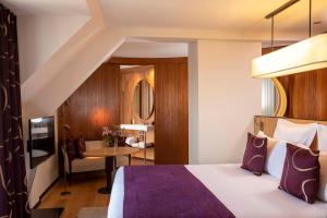 a hotel room with a bed and a table at Hotel Maison FL in Paris