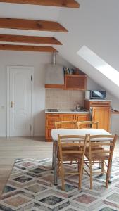 a kitchen with a table and chairs in a room at Vila Elvina in Palanga