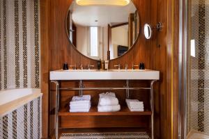 a bathroom with a sink and a mirror at Hotel Maison FL in Paris