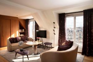 a living room with a couch and a table at Hotel Maison FL in Paris