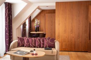 a living room with a couch and a table at Hotel Maison FL in Paris