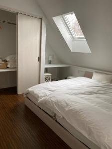 a bedroom with a white bed and a skylight at V-WIN - Vacation STAY 07301v in Niseko