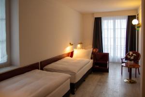 Una cama o camas en una habitación de Boutique City Hotel Gallo