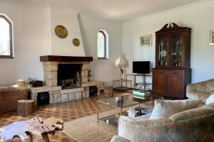 a living room with a couch and a fireplace at Oak Valley Flats Casa do Pinhal Colares in Colares