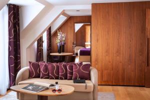 a living room with a couch and a table at Hotel Maison FL in Paris