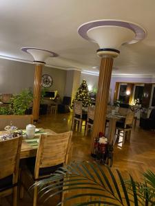 a dining room with two large columns and a christmas tree at Hotel Sonnenhof in Sindelfingen