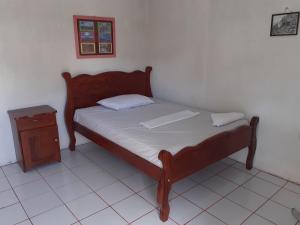 a bedroom with a bed with a laptop on it at Guest House Nena in Moyogalpa
