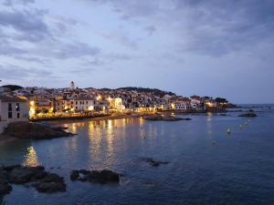 a view of a town with lights in the water at Ca la Caterina in Peratallada