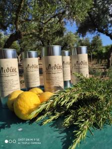 a group of three bottles of massage moisturizers and some lemons at Lithies Farm Houses in Vasilikos