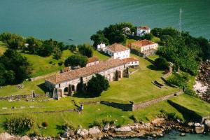 an old house on an island in the water at Pousada Arquipélago in Florianópolis