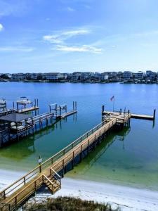 a dock on the water with a person standing on it at Harbor Inn in Wrightsville Beach