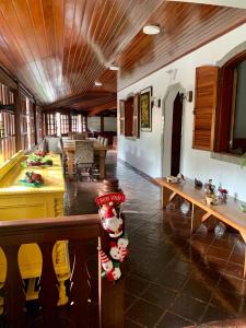 a living room with a table and a pool table at Hotel Buriti da Serra in Itaipava