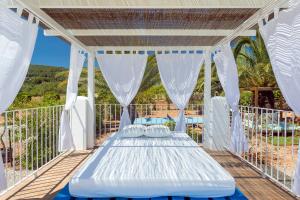 a bed on the deck of a house at CANA MARINA Family Friendly in Santa Eularia des Riu