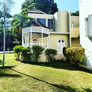 a house with a gazebo in the yard at Columbus Heights Apt 26 F in Ocho Rios