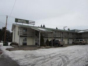 a motel with a truck parked in front of it at Fireweed Motel in Smithers