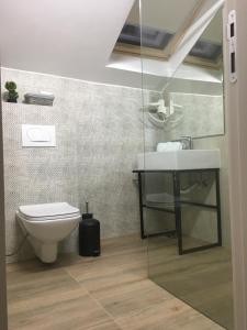 a bathroom with a toilet and a sink at Sleep Inn Prishtina in Prishtinë