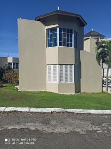 a house with a large window on the side of it at Columbus Heights Apt 26 F in Ocho Rios