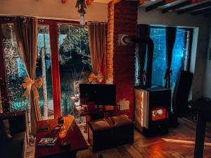 a living room with a fireplace and a brick wall at Cece's home in Mavrovo