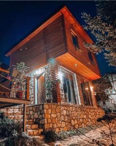 a house is lit up at night at Cece's home in Mavrovo