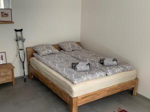 a bed with two pillows on it in a room at Mäekalda Guesthouse Garden Villa with private sauna in Rakvere