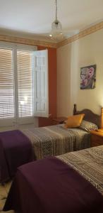 A bed or beds in a room at Piso romantico y espacioso