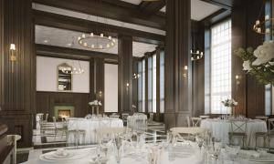 un comedor con mesas y sillas blancas y ventanas en Hotel Morgan a Wyndham Hotel en Morgantown