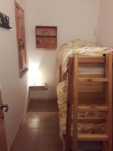 a small room with a bunk bed in a room at Abetone - Parco dei Daini in Abetone