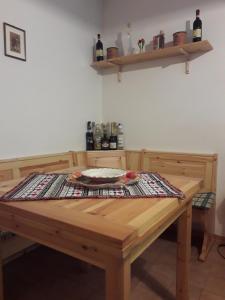 a wooden table in a room with bottles on shelves at Abetone - Parco dei Daini in Abetone