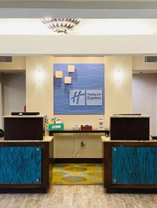 a lobby with a projection screen and two podiums at Holiday Inn Express Fresno River Park Highway 41, an IHG Hotel in Fresno