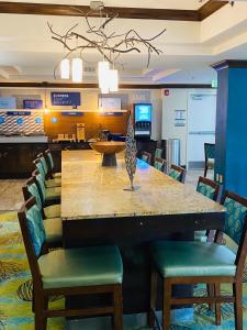 a dining room with a large table and chairs at Holiday Inn Express Fresno River Park Highway 41, an IHG Hotel in Fresno