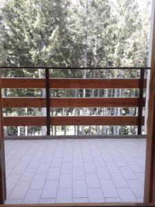 a screened porch with a view of trees at Abetone - Parco dei Daini in Abetone