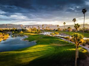 a view of a golf course with palm trees and water at Azul Talavera Country Club in Torreón